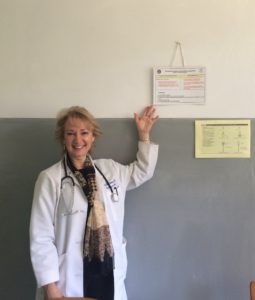 Dr. Mary Ellen Sweeney proudly points to the diabetes guideline cards developed in a collaboration between Emory and AAU and now displayed in the endocrine clinics.